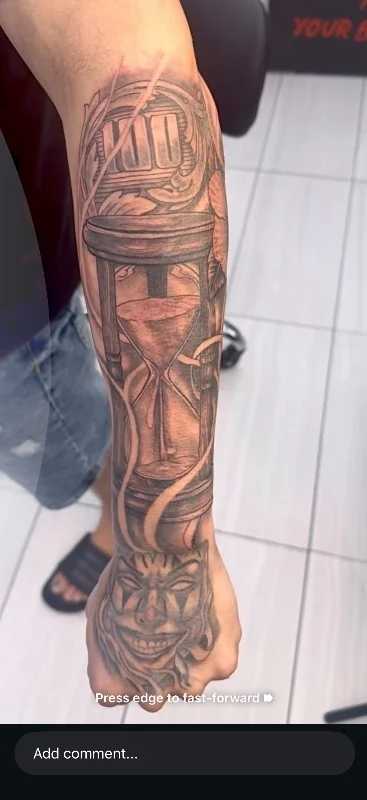 Benson Carlos black and gray realism tattoo of hourglass on forearm in Hawaii